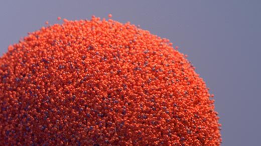 An orange ball decomposing into points and rematerializing as two balls, each the same size as the first.