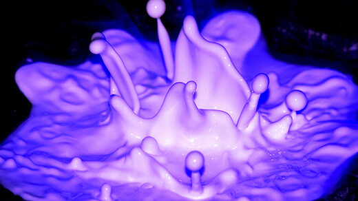 Fluorescent purple liquid splashes.