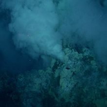 A hydrothermal vent spewing hot, mineral-rich fluid