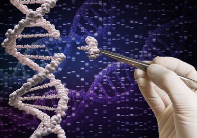 A gloved hand holds a tweezer and pulls a section of DNA away from a double helix