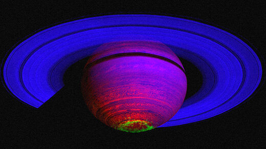 The ringed planet Saturn showing its aurora in green.