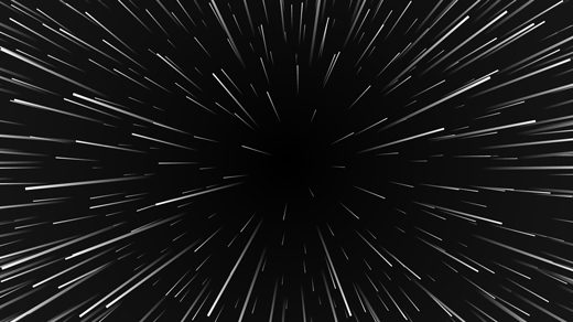 An image of space with lines emanating from a central point, as if the viewer is traveling at warp speed.